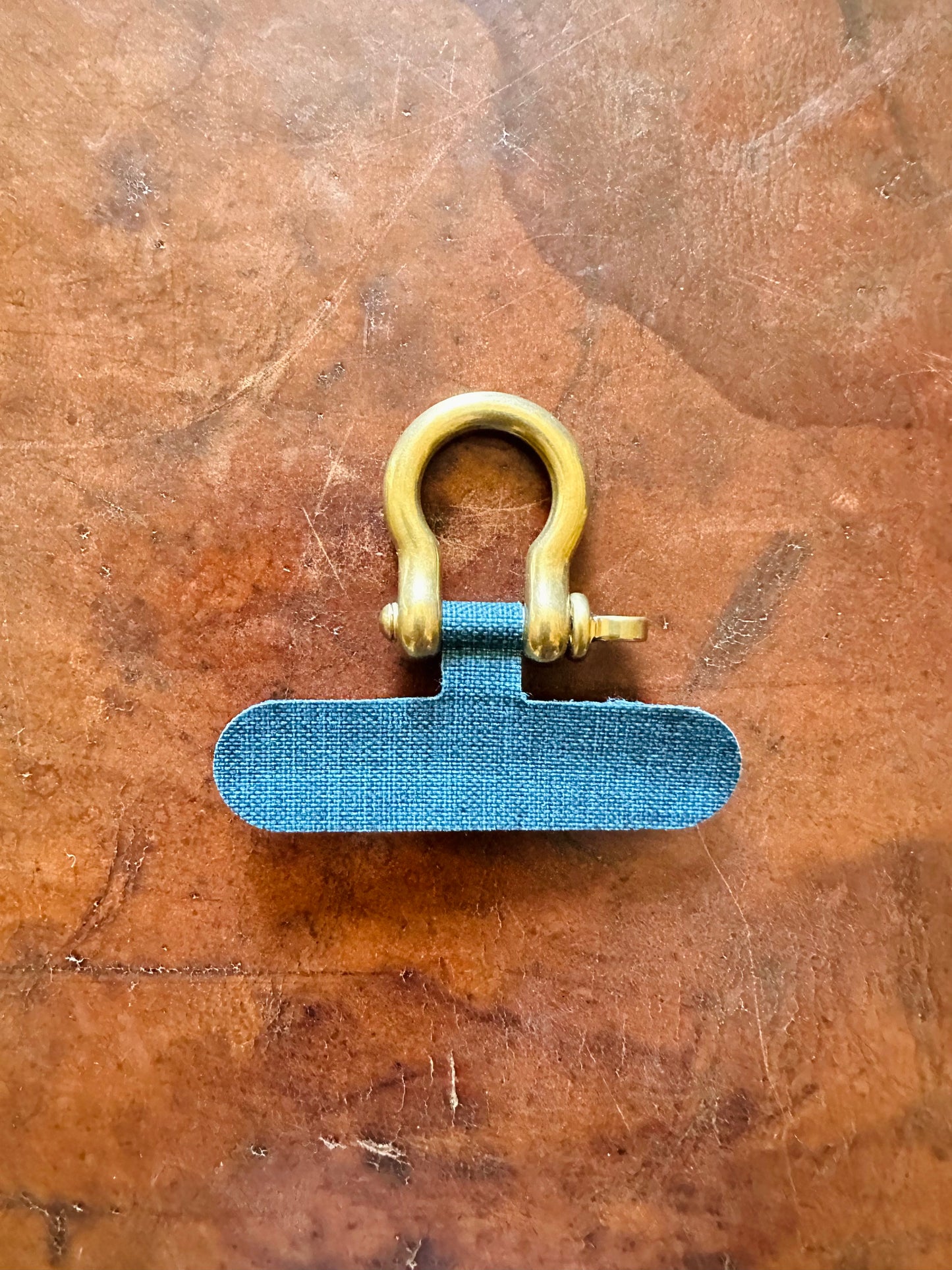 Phone case tether and shackle